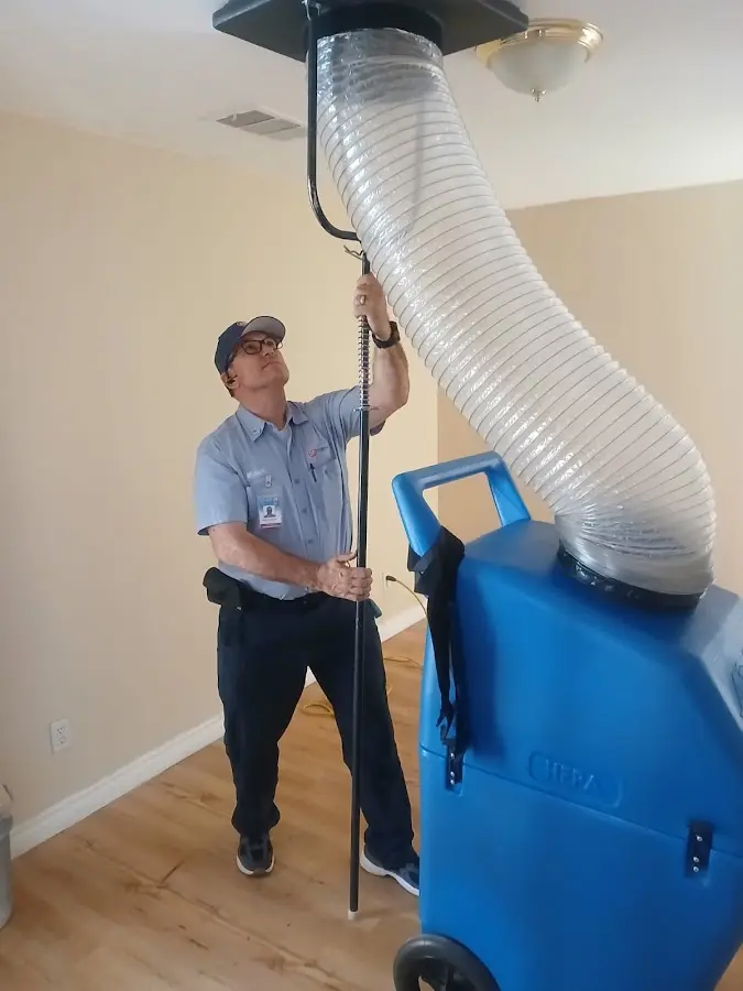 Furnace Tune-Up technician using HEPA equipment in Apollo Beach